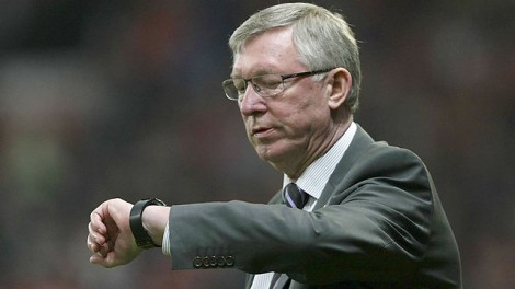 Sir Alex Ferguson checks his watch